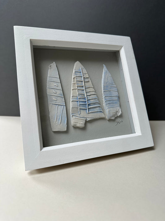 Small ceramic pieces in frame