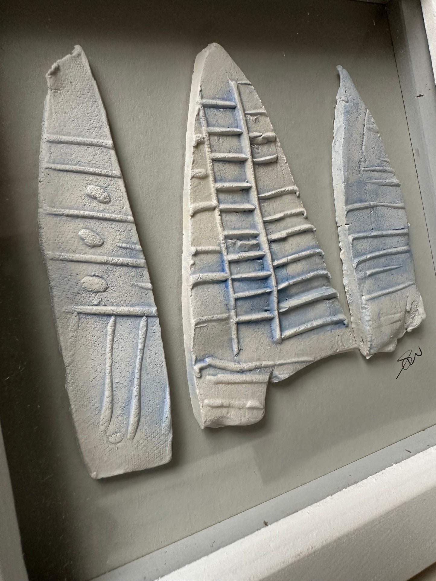 Small ceramic pieces in frame