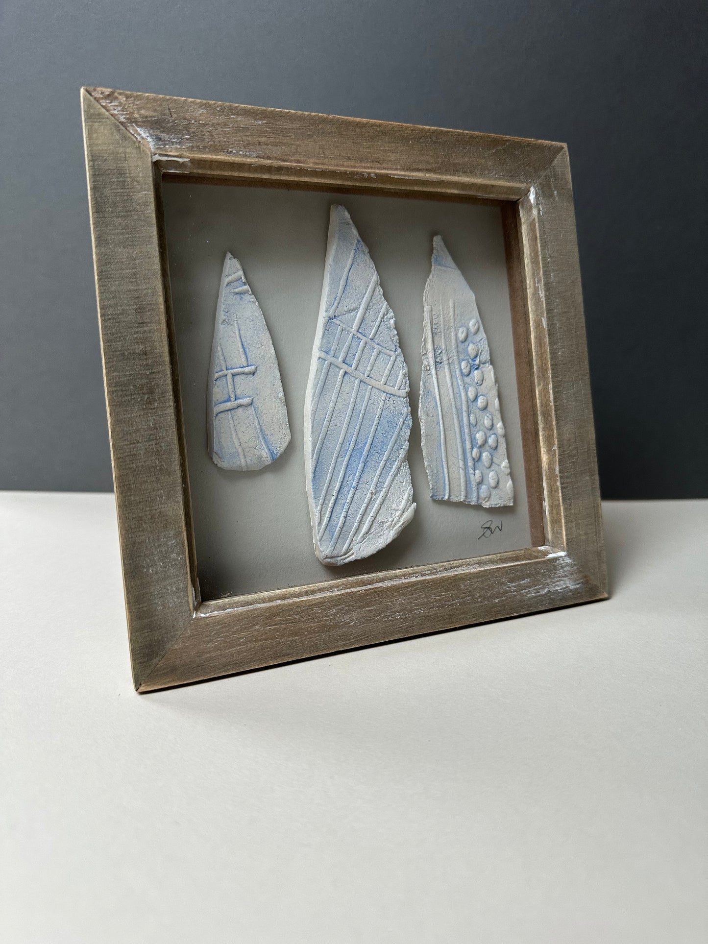 Small ceramic pieces in frame