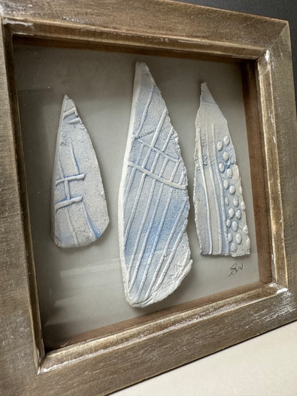 Small ceramic pieces in frame